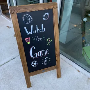 a chalkboard sign outside a store