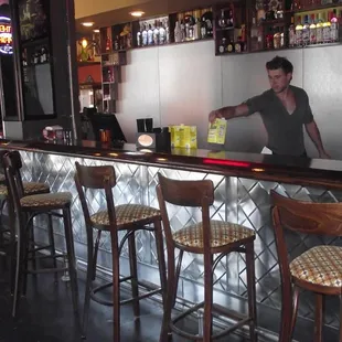 a man behind a bar counter