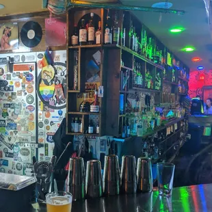 End of the bar closer to the door. (The important end... where the popcorn is).