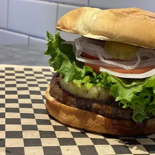 a hamburger with lettuce and tomato