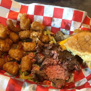 Raw burger with tater tots.