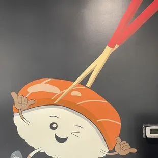 a sushi with chopsticks