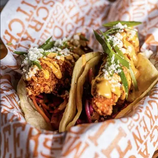 two chicken tacos in a basket