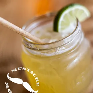 a glass of lemonade with a wooden spoon