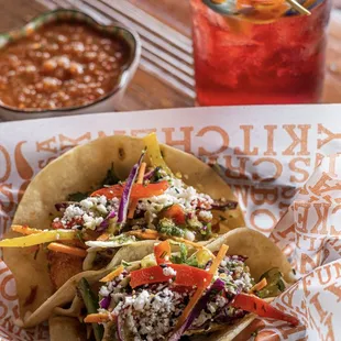 a plate of tacos and a drink