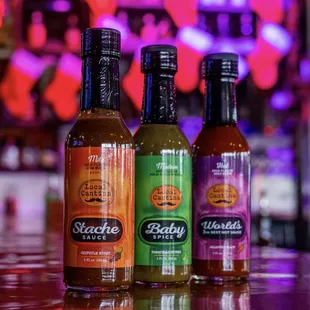 three bottles of hot sauce