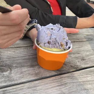 Scoop of pistachio (bottom) and Cookie Monster ice cream (top)