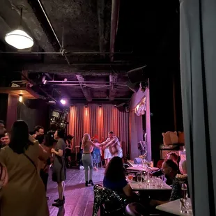 a group of people dancing in a dark room