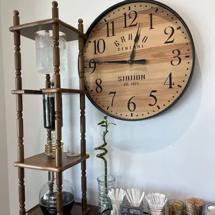 a clock on a wall above a shelf