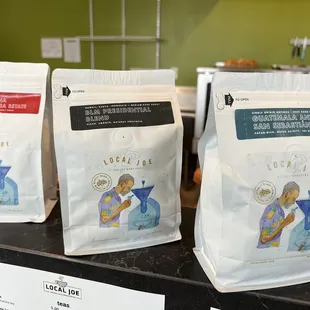 three bags of coffee on a counter