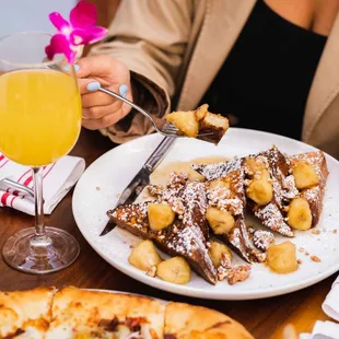 a plate of french toast and a glass of orange juice