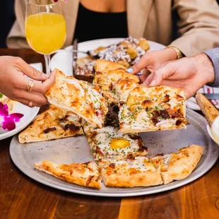 a group of people eating pizza