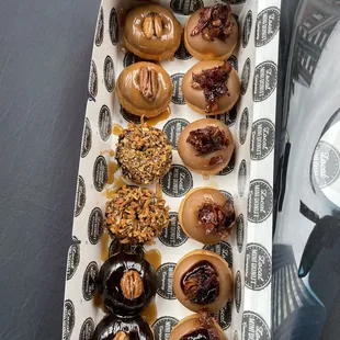 12 Pieces Mini Donuts with four maple bacon donuts on the upper right which is their #1 seller