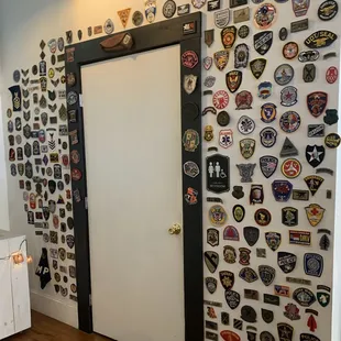 A wall of unit patches.