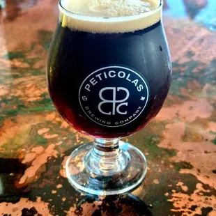 a glass of beer on a table