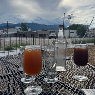 two glasses of ale and a pitcher of ale