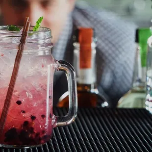 a mason jar with a drink in it