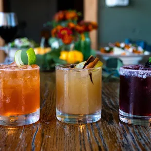 three cocktails on a table