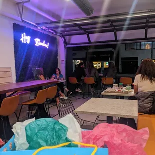 people sitting at tables in a restaurant