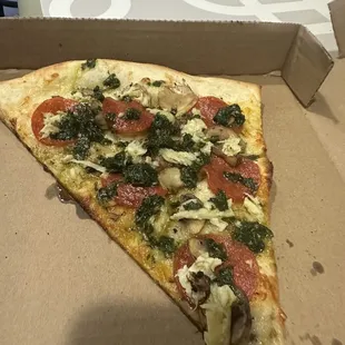 Customized pizza slice with pepperoni, mushroom and artichoke