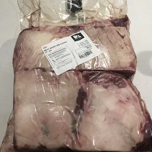 two pieces of meat wrapped in plastic