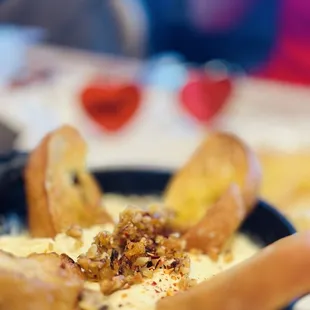 a bowl of soup with bread sticks