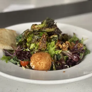 Honey Ginger-Roasted Brussels Sprouts Salad - Mixed greens with goat cheese, candied walnuts in a lemon zest and roasted garlic vinaigrette