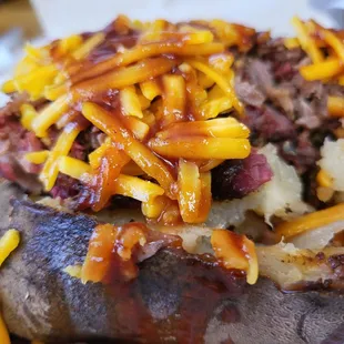 a baked potato topped with cheese
