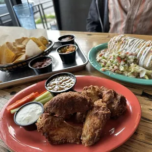 Wings with jalapeño bacon jam on the side, Locales burrito and chips with a trio of salsa