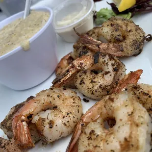 a plate of shrimp and a bowl of soup