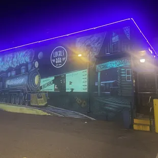  a mural of a train on the side of a building