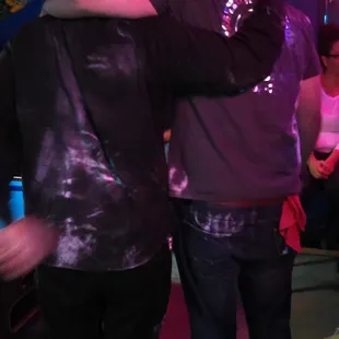  two men hugging each other in a bar