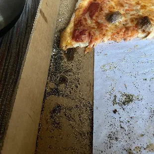 Piles of blackened cornmeal falling off the bottom.