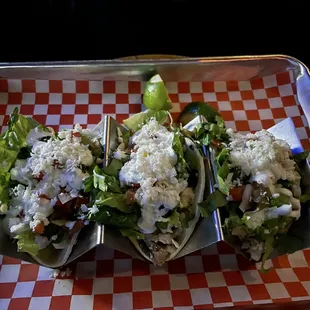 three tacos on a tray