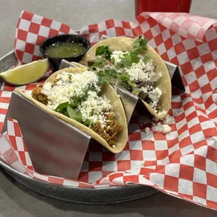 two tacoss on a plate