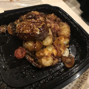Carry out tenderloin with potato hash, sun dried tomatoes and mushroom Demi sauce