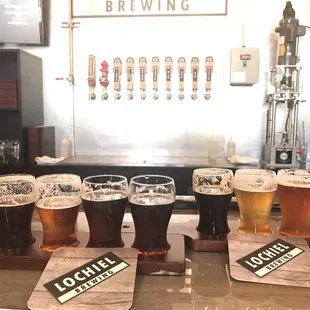 a row of beer glasses on a bar