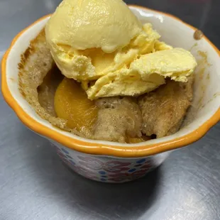Homemade peach cobbler with vanilla or homemade ice cream.