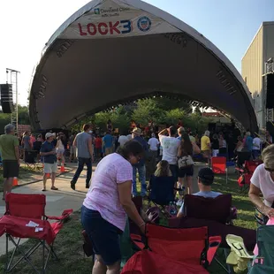 a crowd of people sitting in lawn chairs