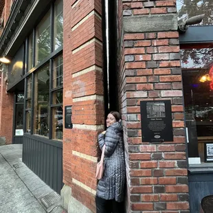 Outside with an very narrow gap between buildings.