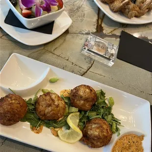 Crab cakes, fruit bowl and French toast with wings