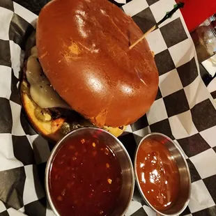 a burger with a side of sauces