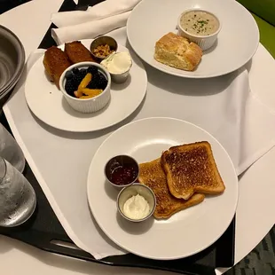 Room service order with a side biscuit and gravy, griddled banana bread, and side of toast.