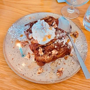 a plate of french toast topped with whipped cream