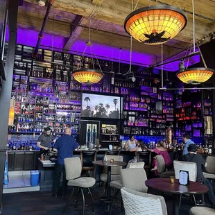 people sitting at tables in a bar