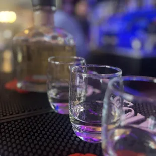three shot glasses on a bar