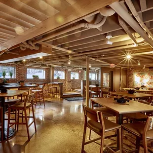 the inside of a restaurant with tables and chairs