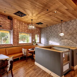 a kitchen with a brick wall