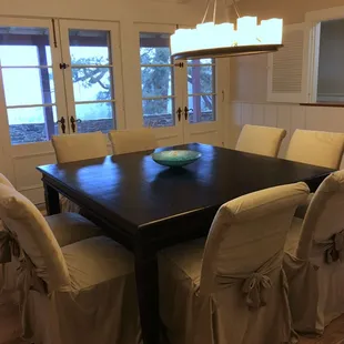 Formal dining room seating for 8 with view of north patio and lake.