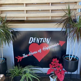 a sign that says denton the home of happiness